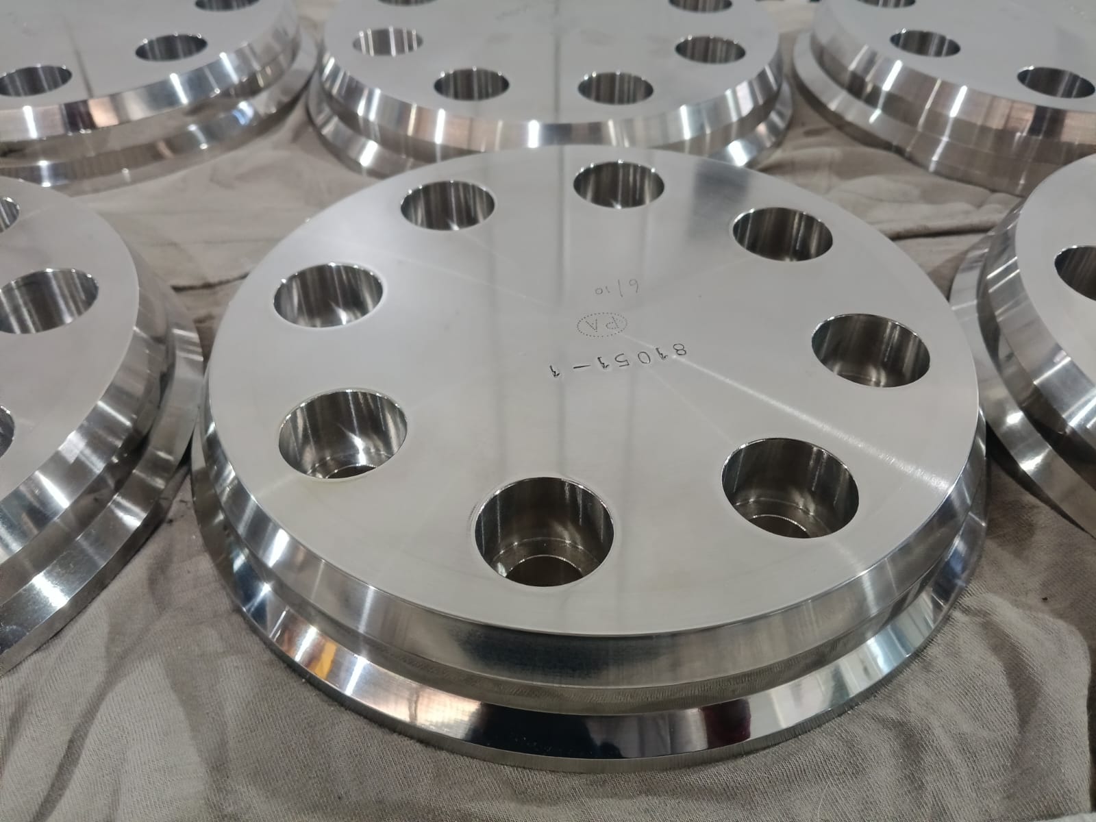 Batch of polished stainless flange discs