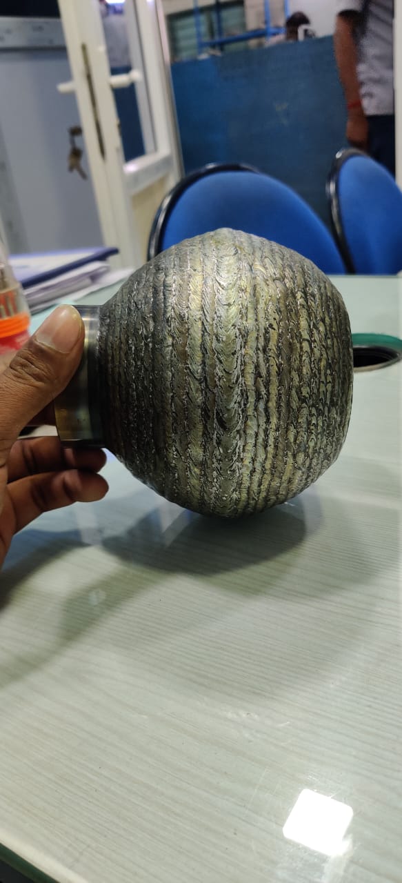 Clad ball valve ball with weld overlay buildup